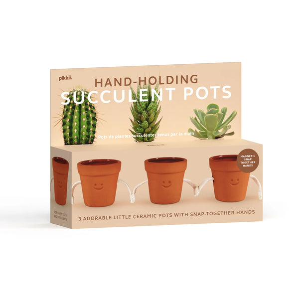 HAND HOLDING PLANTER POTS